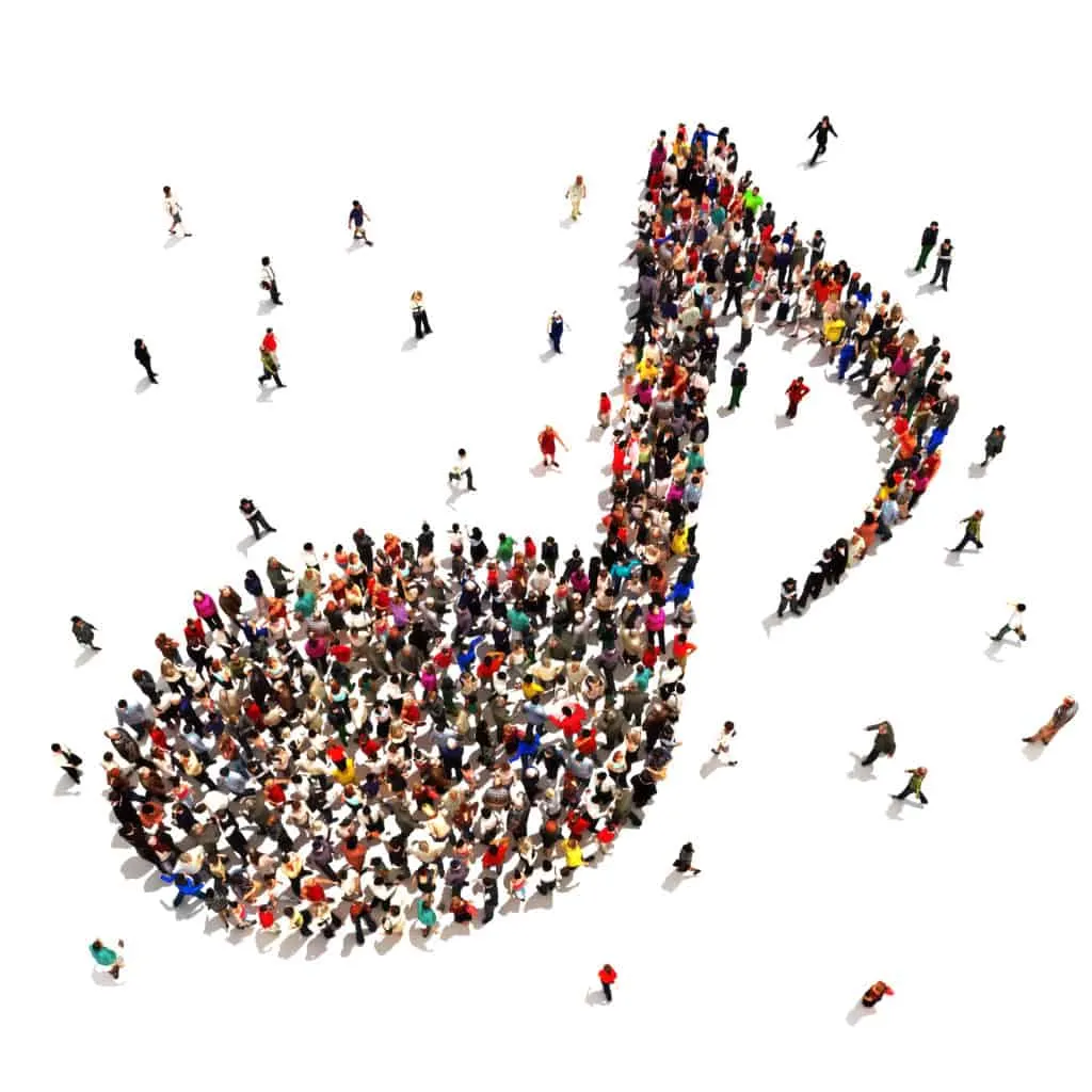 Image of a crowd of people from above standing in the shape of an eighth-note